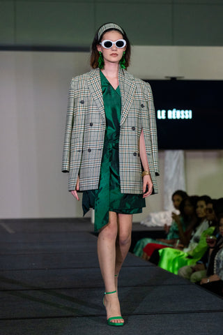 Le Reussi Fashion show with green oversize blazer and green shining dress