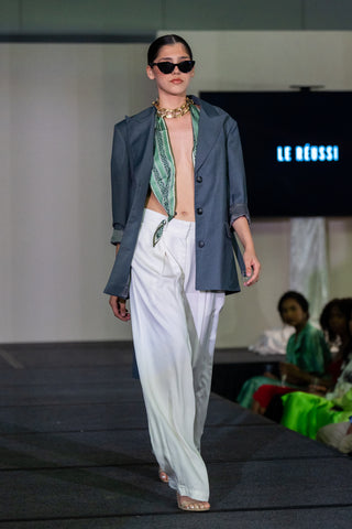 Le Reussi fashion show with model wears a open oversize blue blazer with white relax trousers