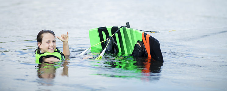 Kid getting up on a Wakeboard