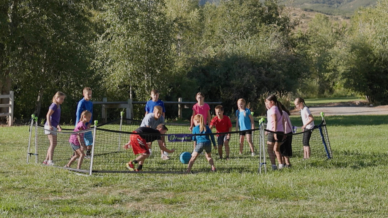 fun pe game gaga ball froggy ball being played outside on grass