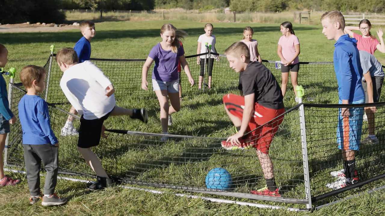 Boy stepping out of gaga ball pit after getting touched by the ball