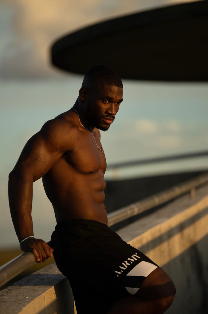 man standing on a bridge after a workout