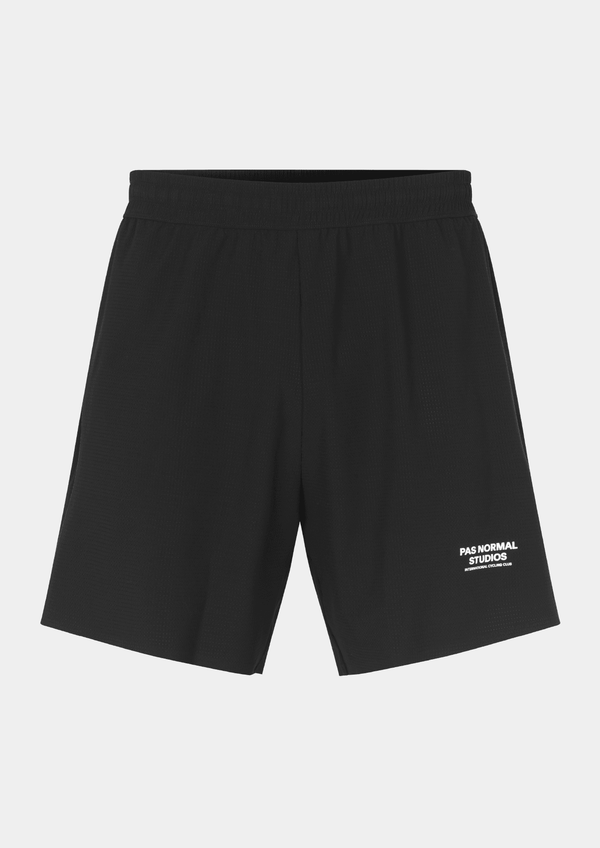 Front view of the Pas Normal Studios Men’s Balance Shorts  in the color black. Adjustable elastic waistband and tight fit with Pas Normal Studio font logo in white on lower left side. These shorts are not tight fitting.
