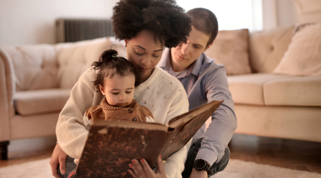 parents telling story to toddler