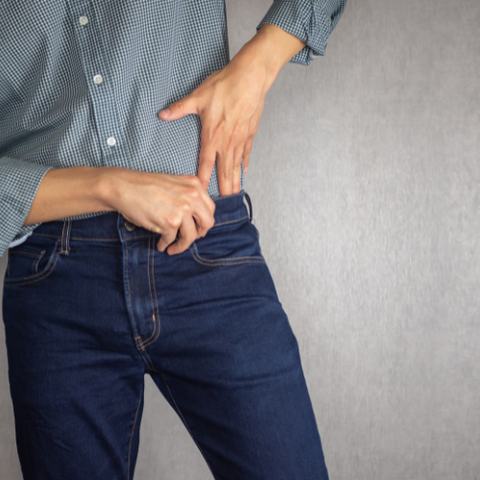 Man Tucking In His Shirt into Jeans