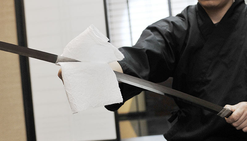 Wiping Japanese sword blade with Japanese paper