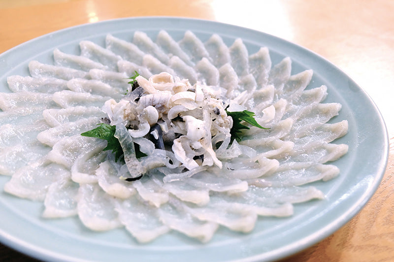 Fugu, a poisonous delicacy, arranged  beautifully on a plate.