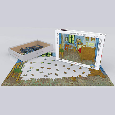 Top view of Eurographics' Fine Art Collection puzzle featuring Van Gogh's Bedroom In Arles, with pieces scattered across a wooden table.