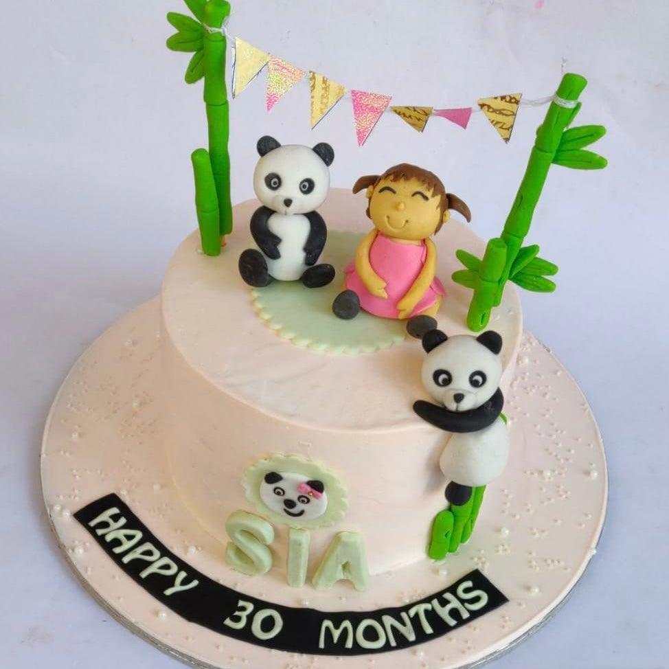 Pandas with girl cake - Animal Theme Cakes - Kukkr India