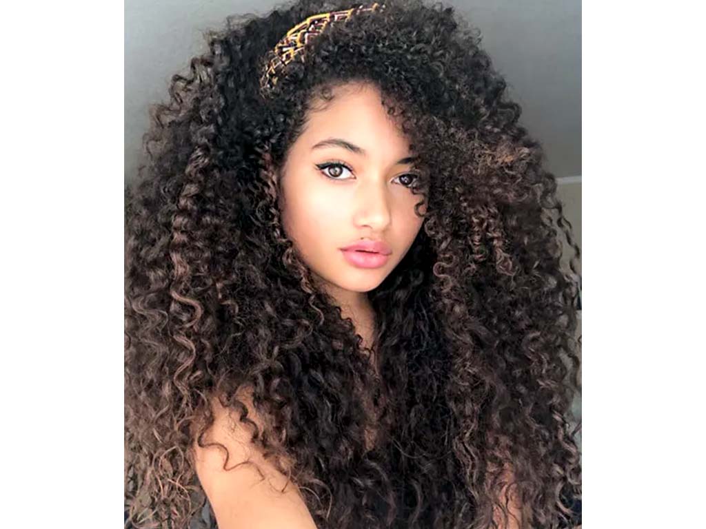 girl get a curly brown balayage hair color