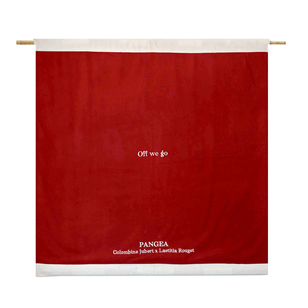The back side of the flag is brown/red. The name of the flag and the creators is embroidered in white. | © Pangea 2024