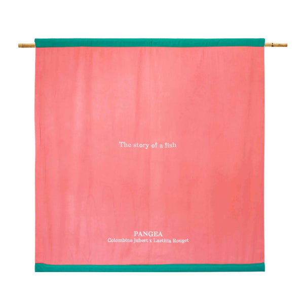 The back of the flag is a salmon pink colour, and has the name of the flag and the creators embroidered in white. | © Pangea 2024