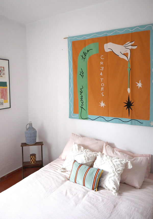 The flag is hung on the wall of a bedroom, above a bed. | © Pangea 2024