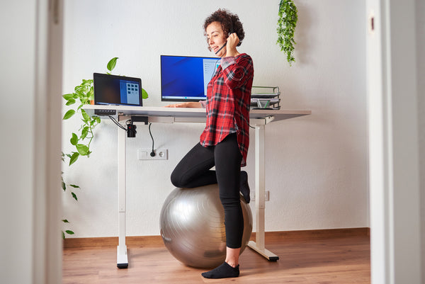 woman teleworking adjustable standing desk