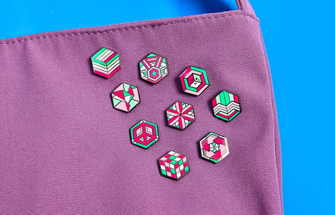 9 unique geometric abrosexual pride pins on a bag