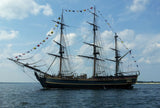 Three mast ship on the ocean