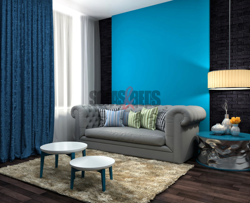 Grey sofa styled in a teal colour | Sofas & Beds