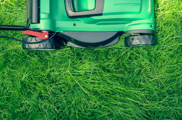 Lawn mower on grass promoting proactive lawn care
