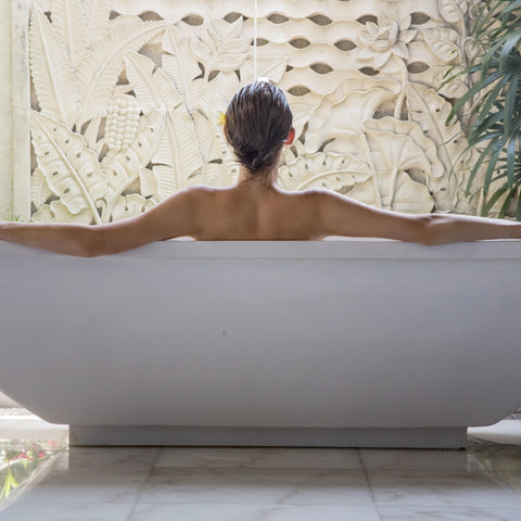 woman relaxing in bath practicing a self care activity