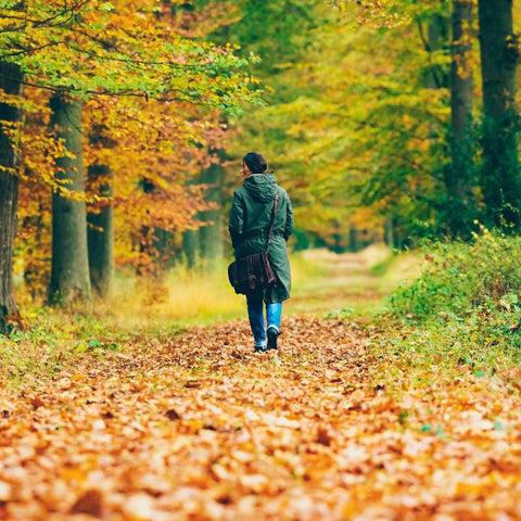 woman walking in nature to practice self care