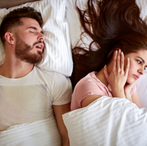 Man Sleeping Next To Wife With Obstructive Sleep Apnea