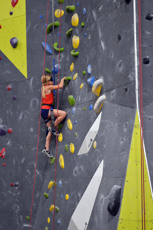 Image showing young  blindfolded climber climbing rock wall at Blind Spot event.