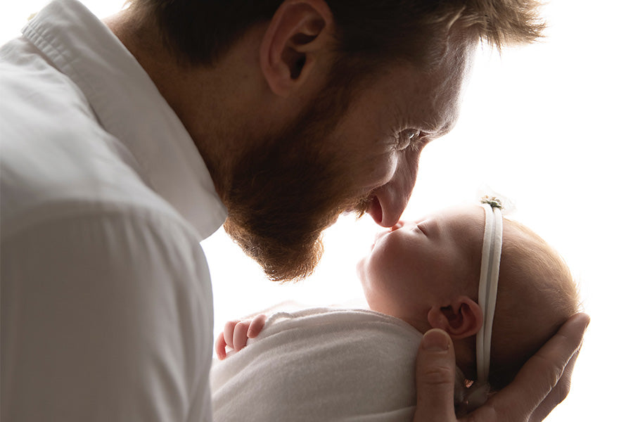 Brad cradles Rooney Mae, their noses touch.