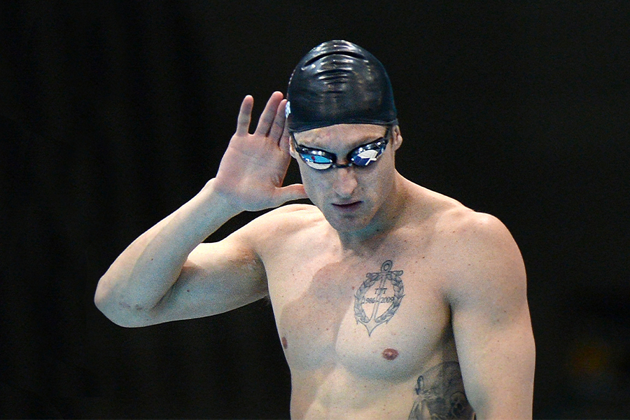 Bradley Snyder listens for the results, donning a black swim cap and goggles.