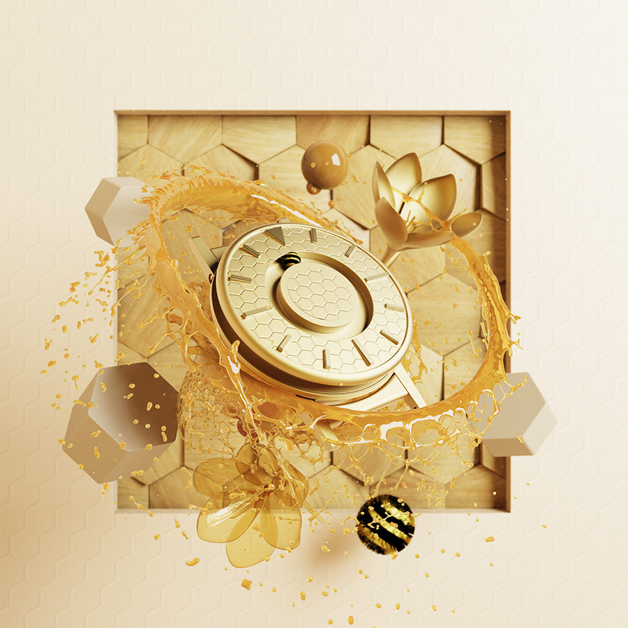 Image shows a visual render of the Bradley Timepiece in gold, the face is patterned with a honeycomb pattern and the minute ball bearing is represented by a honey bee; curled into a ball. The timepiece is floating, surrounded by liquid honey; spinning and spraying outwards from the hour ball bearing track. The backdrop is made up of wooden block panels, in the shape and panel of a honeycomb.