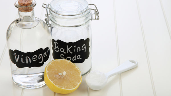 vinegar and baking soda in bottles for cleaning naturally