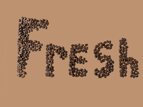 The word “fresh” made up of coffee beans