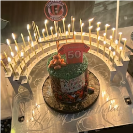 50th birthday party with Celebration Stadium candle holder and Bengals-theme cake