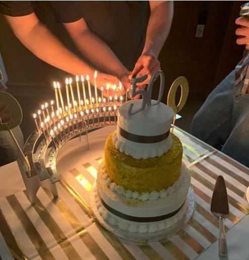 50th birthday theme with 3-tier cake, Celebration Stadium candle holder.  Customer review and photo from Connecticut.