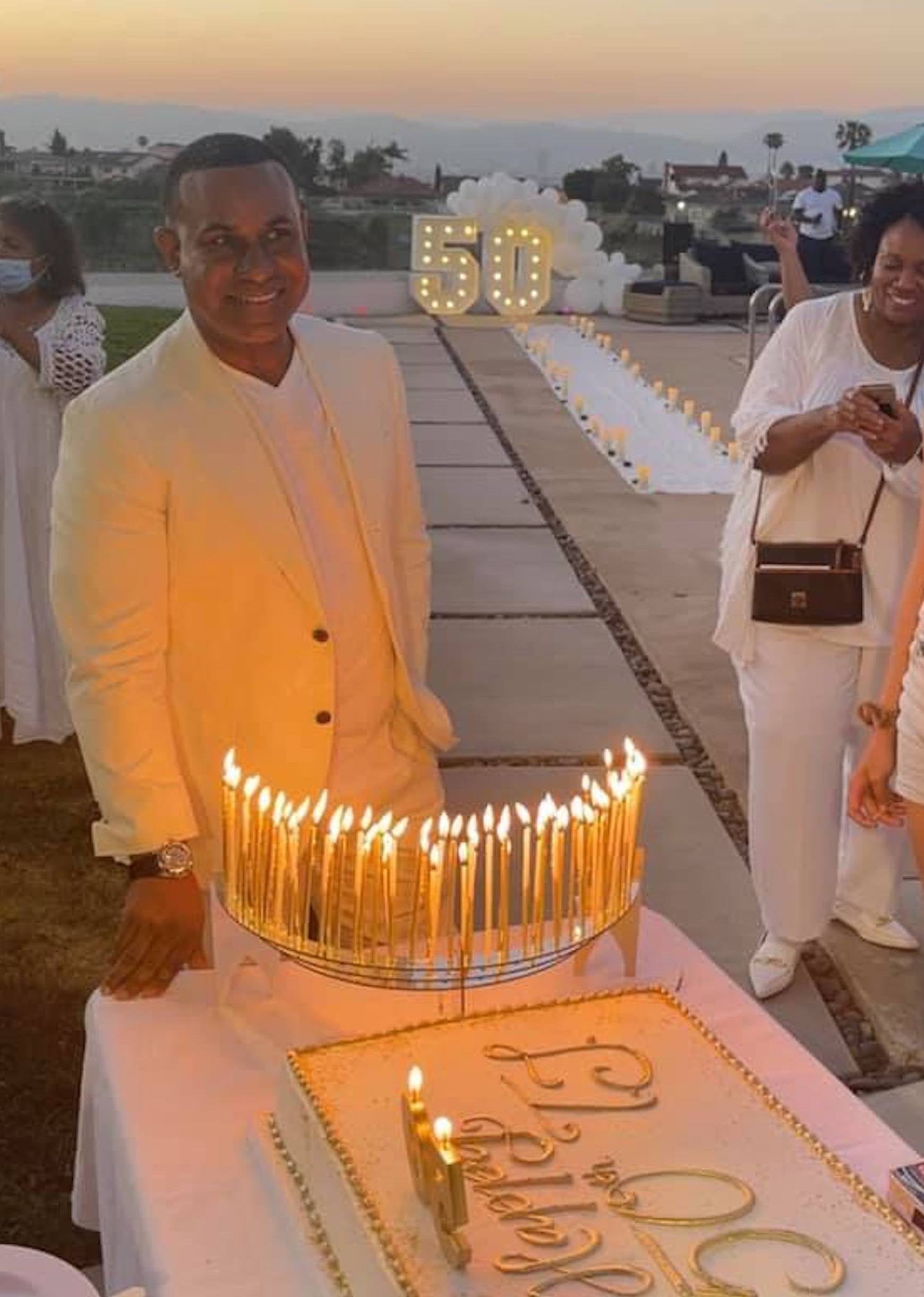 Spectacular 50th-theme birthday outdoor party, Celebration Stadium with extra-tall gold candles.  Customer photo from California.