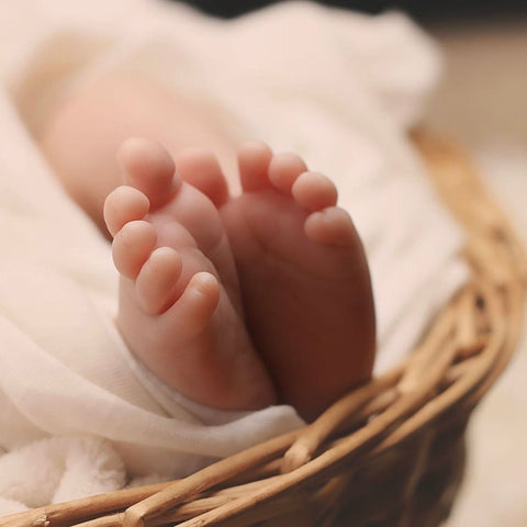 baby feet sticking out of soft fabric