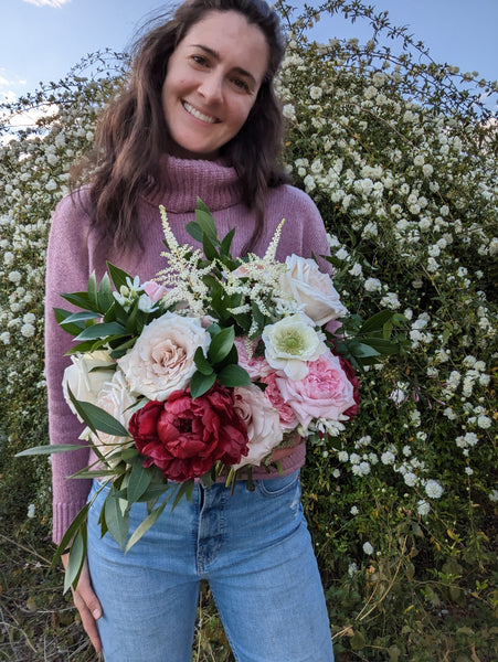 Candid image of florist holding bouquet