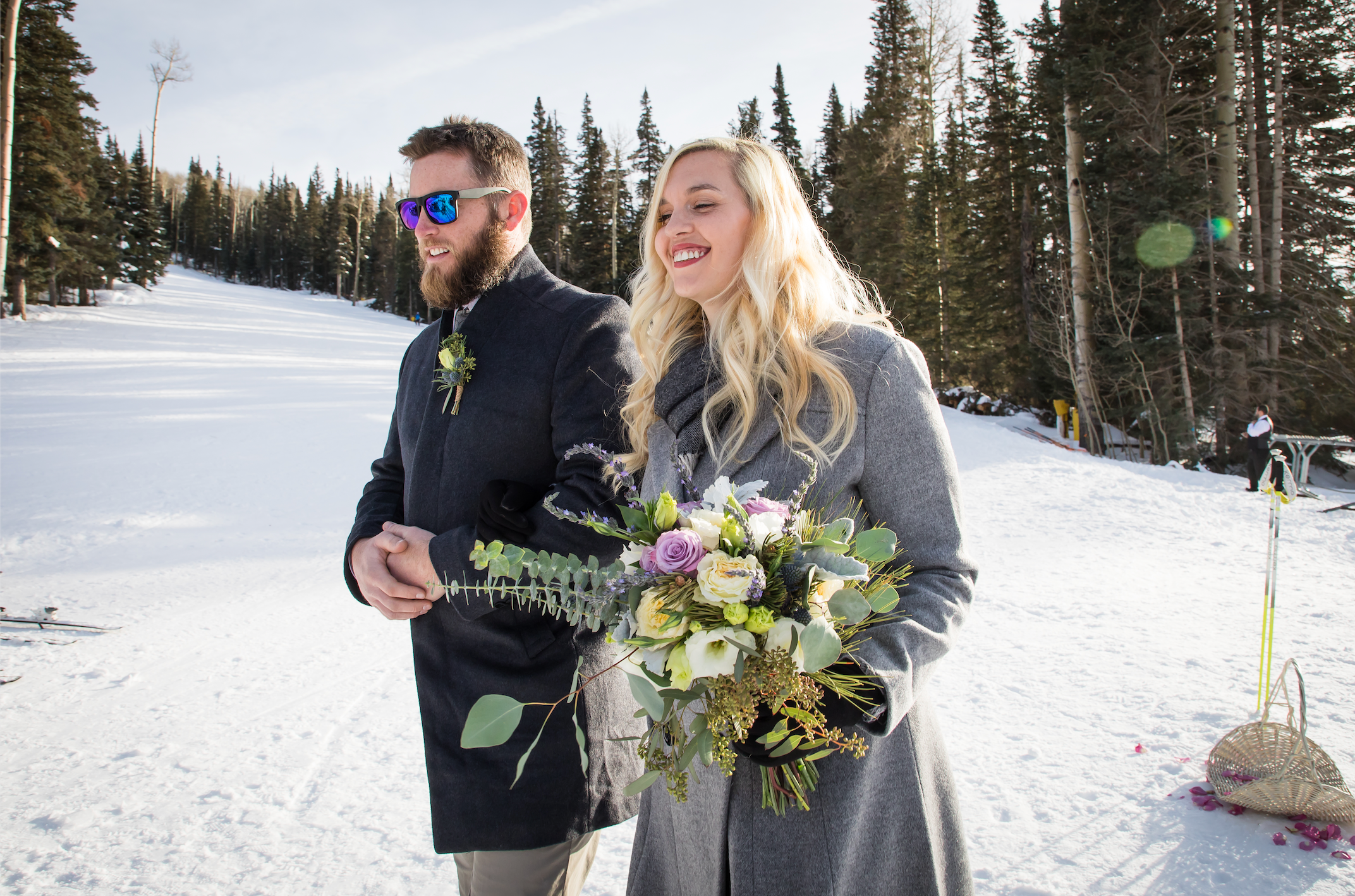 A wedding party walks down the aisle in ski boots during a Flagstaff winter wedding