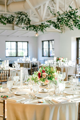 An airy and light reception hall with wedding flowers