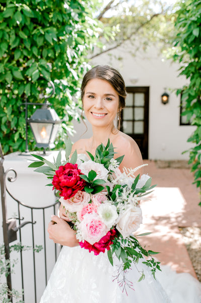 A Bride holds flowers outside Casa Paloma at El Chorro Lodge