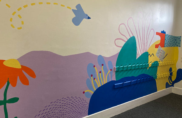 primary school mural in library featuring bright shapes and colours