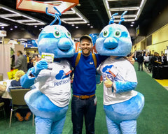 reporter with two bug mascots