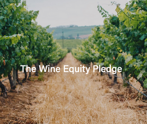 A lane of covercrops between two vineyard rows with White Text: The Wine Equity Pledge