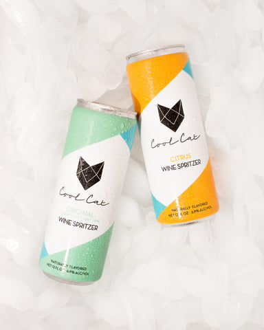 Cans of Cool Cat's original and citrus flavor of canned spritzers, featured in Artful Living.