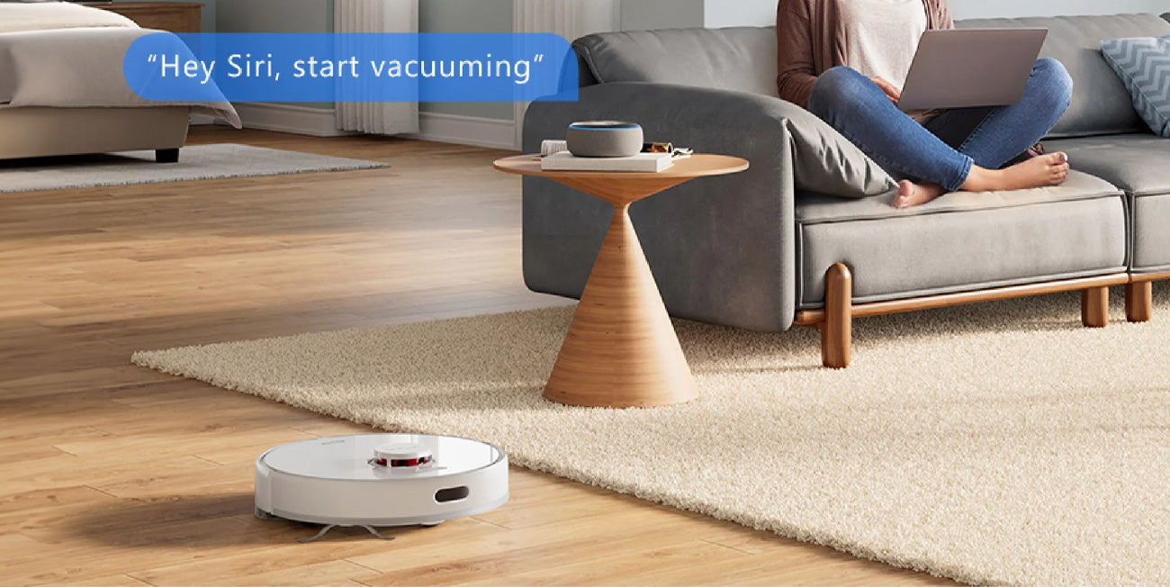 dreame robot vacuum with teacher on the sofa using laptop
