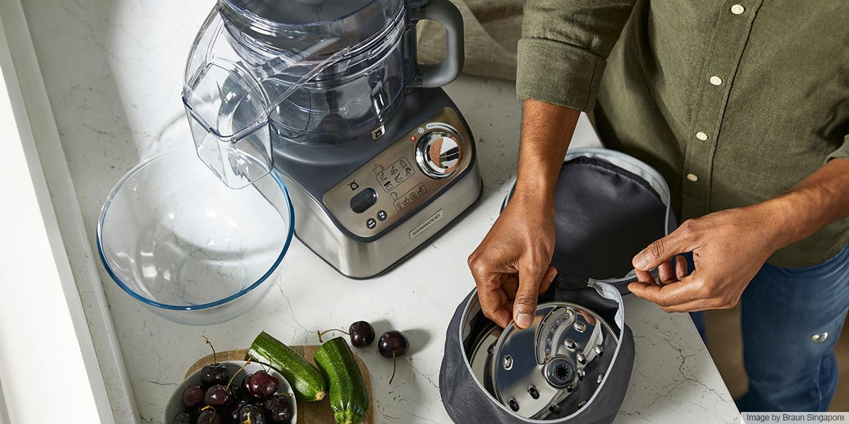 man setting up food processor on the table