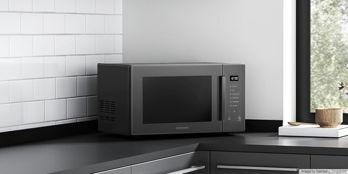 black samsung microwave on a black kitchen countertop