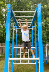 Elementary age boy goes across SwingSesh monkey bars