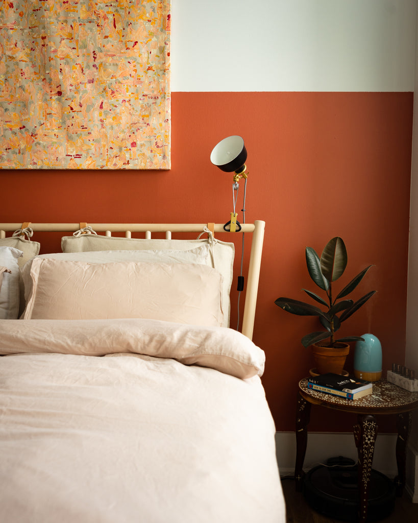 The dark, thick leaves of the rubber plant compliment the warm tones of the principal bedroom.