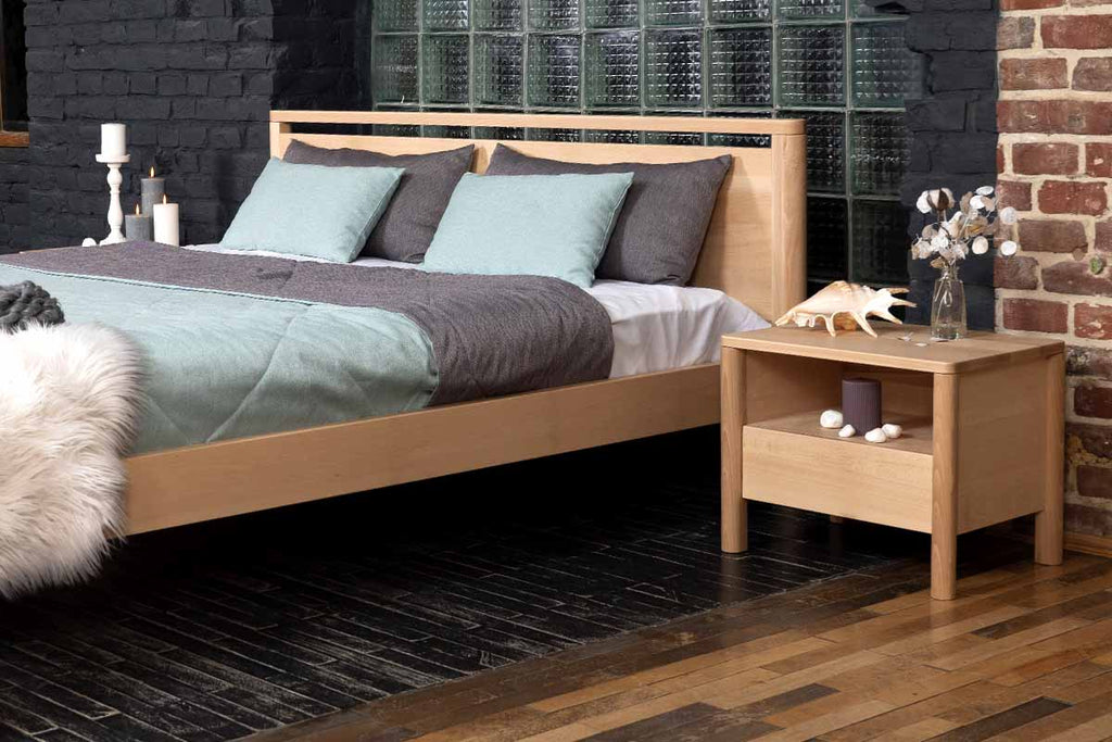 Double bed with headboard and two bedside tables, all made of beech wood. Nice interior in Scandinavian style.