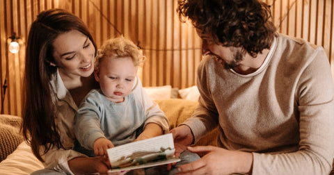 parents reading to baby